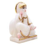 White decorative statue with gold accents.